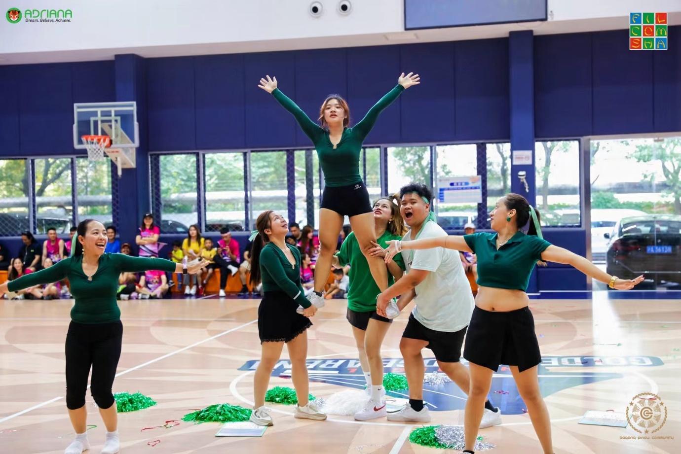 A group of cheerleaders in a gymDescription automatically generated