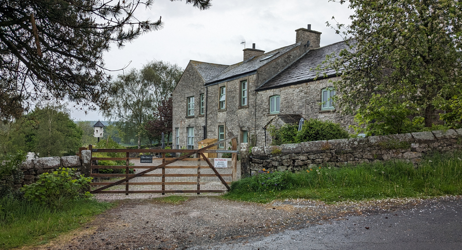 A stone house with a gate

Description automatically generated