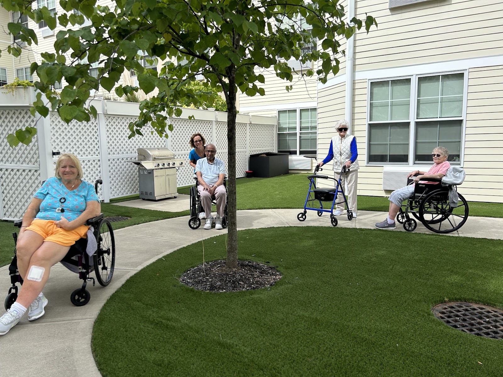 People in wheelchairs outside of an in-home dementia care facility