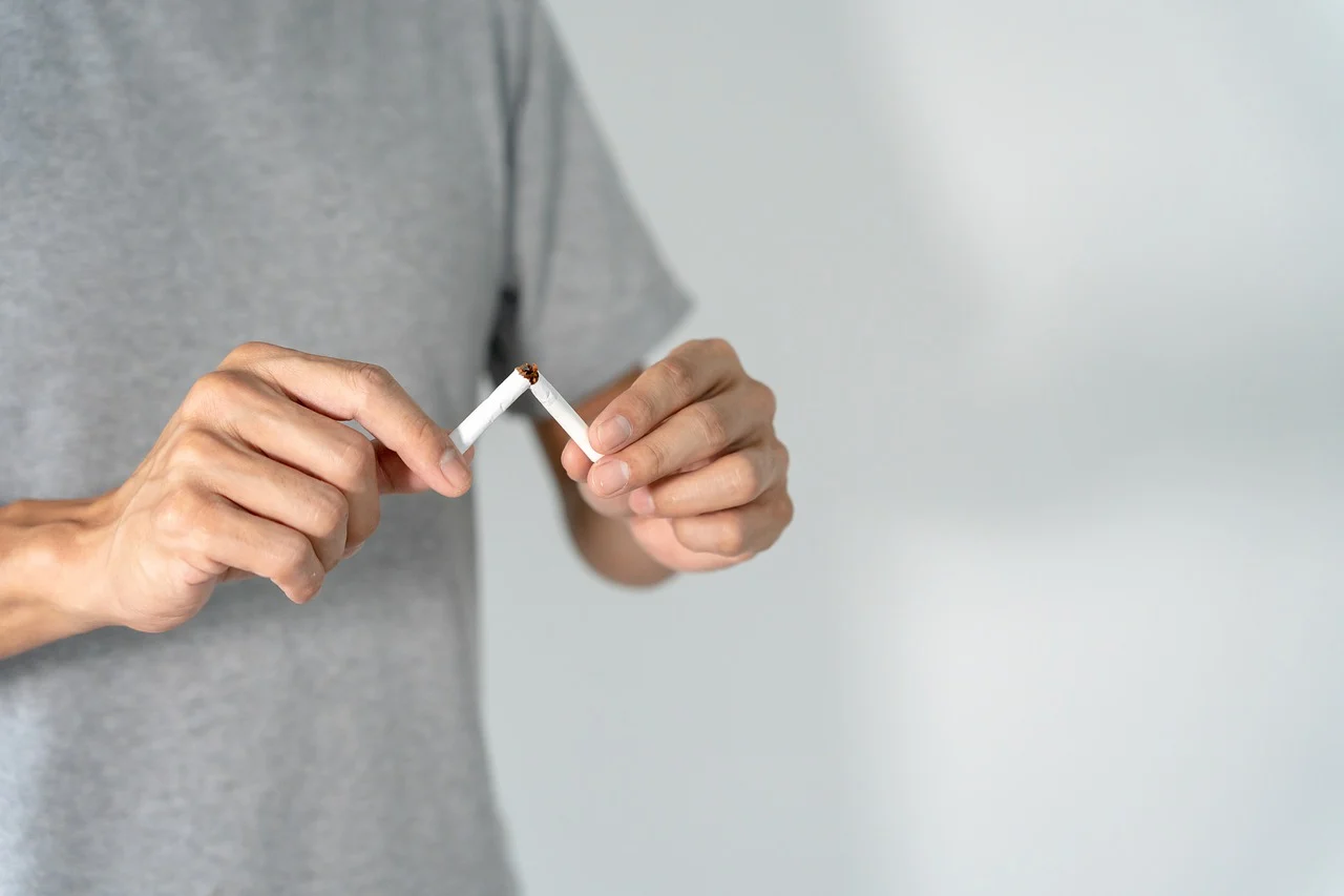 a person breaking a cigarette