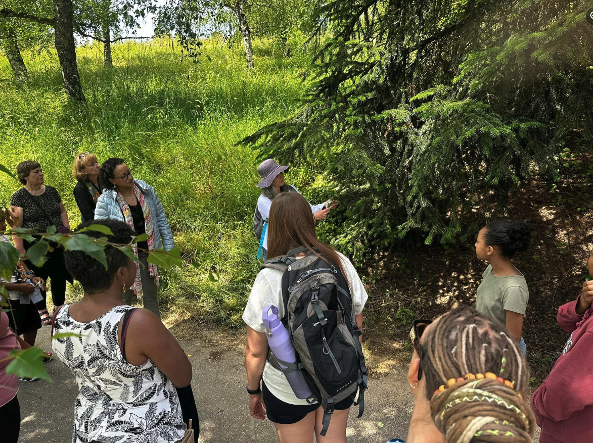 Dean of Aromatherapy Amanda Lattin points out a tree to the group on the Botanical Walk