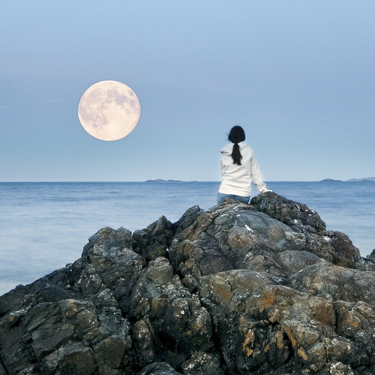 Romantic Lonely Girl and Moon
sitting on the sea shore