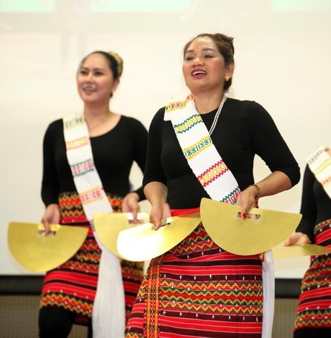 A group of women wearing traditional clothingDescription automatically generated