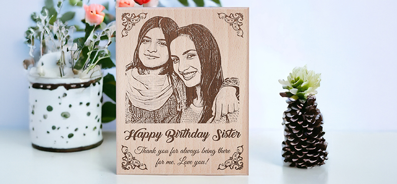 A wooden photo frame with engraved picture