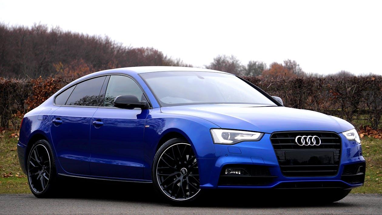 Free Blue Audi Sedan Parked Near Forest Stock Photo