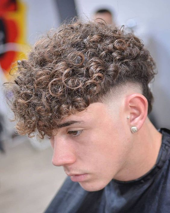 Side view of a guy wearing the Curly Hair Skin Fade 