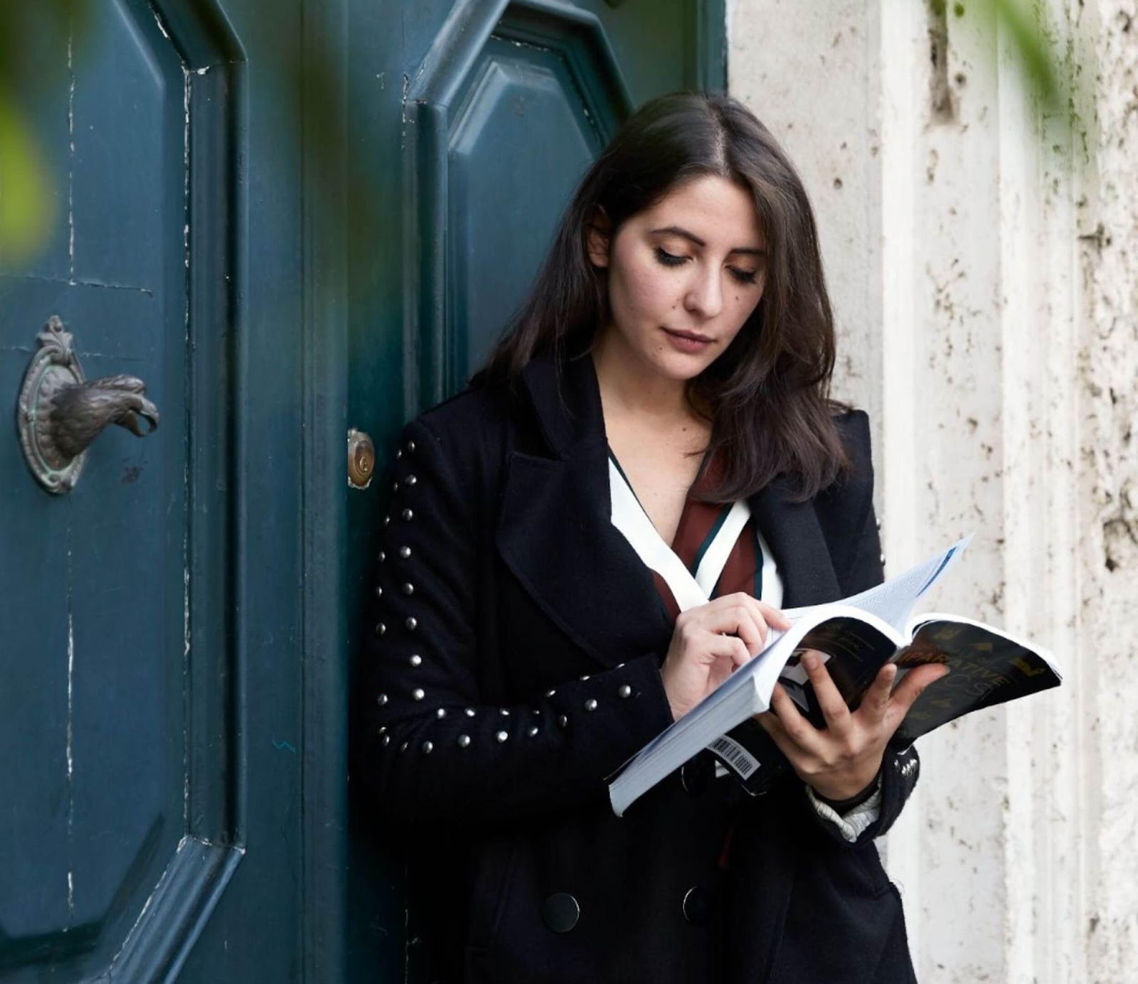  study abroad student reading a book outside