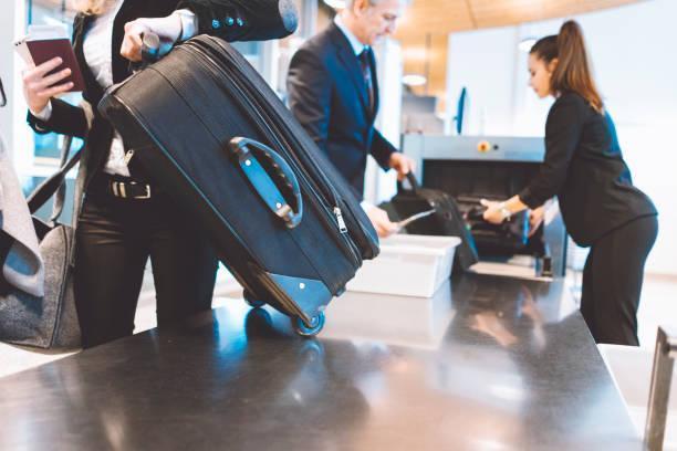 At the airport security check point Passengers going trough security check at the airport. airport screening stock pictures, royalty-free photos & images