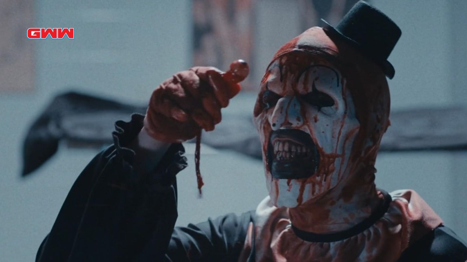 Art the Clown looking at an extracted eyeball, cast of Terrifier 3