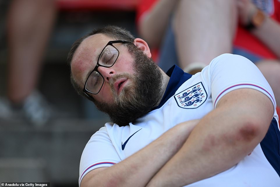 An England supporter at Cologne Stadium in Germany appears to fall asleep during the match between England and Slovenia