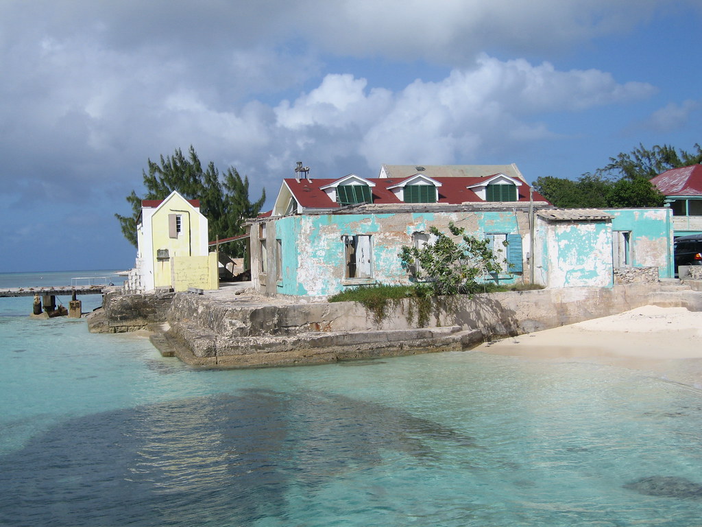 One of the famous point of The Turks and Caicos showing beautiful blue water and a building.