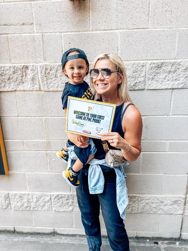 A person holding a sign with a childDescription automatically generated