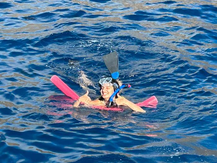 A person in a snorkeling mask and fins swimming in the water

Description automatically generated