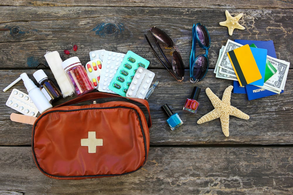 A bag with some travel essential medications along with other accessories.