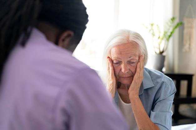 African social worker taking care of a senior woman