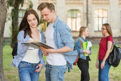 Group of young students in front of school building