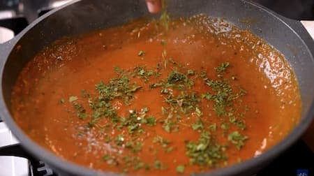 Gravy simmering in a pan with besan and spices.