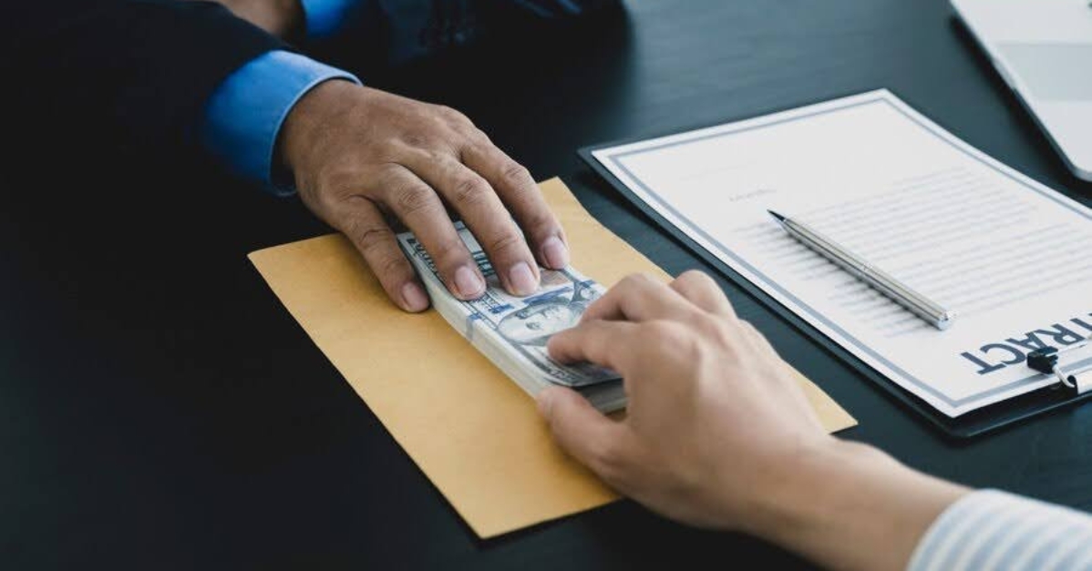 person handing another person money