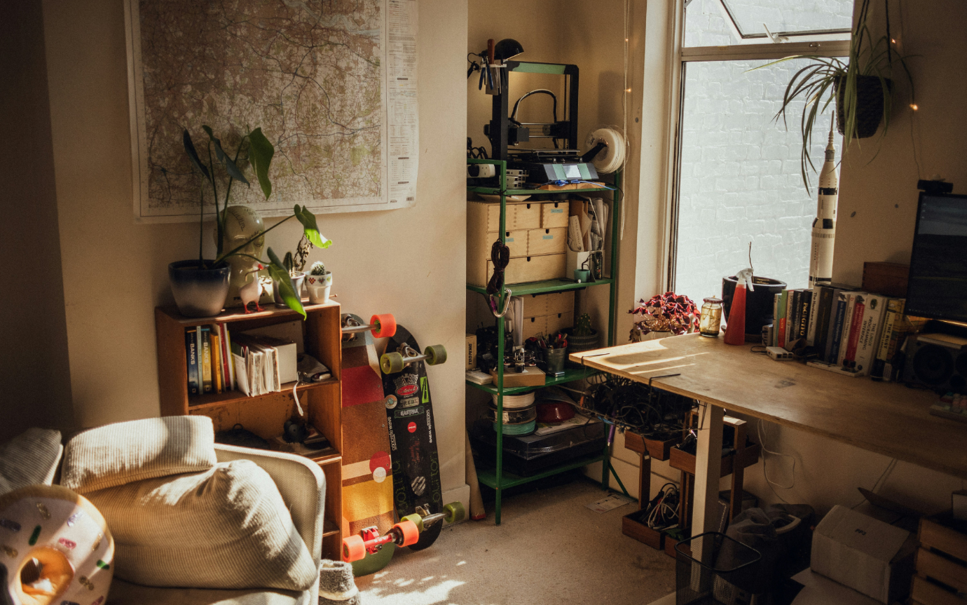 A room with a table and shelves and a skateboardDescription automatically generated