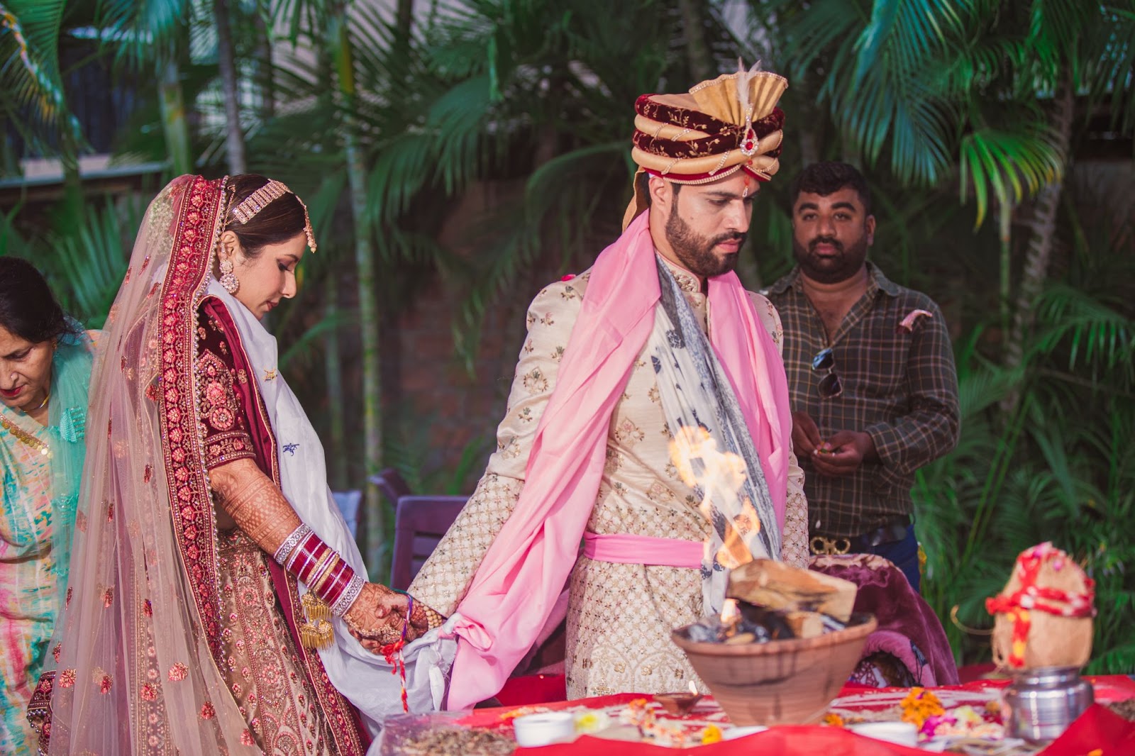 Couple wedding picture - In this beautiful image, the couple is taking pheras around the sacred fire, symbolizing their union in the bond of seven lifetimes. The best wedding photographer in Indore has captured this significant moment with professional expertise. Known for their creative and documentary-style wedding photography, this top wedding photographer in Indore provides affordable wedding photography services. This photograph, part of the photographer's portfolio in Indore, reflects the traditional essence of Indian weddings, perfect for those looking to hire a wedding photographer in Indore.