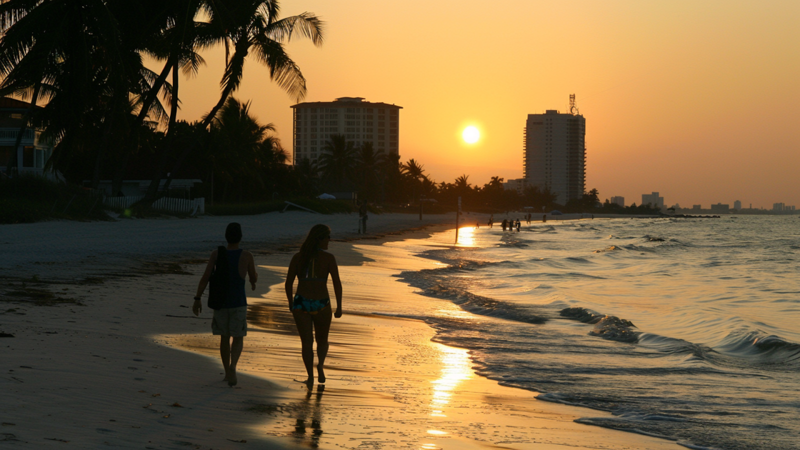 Two people walking towards beach rentals in Fort Myers Beach