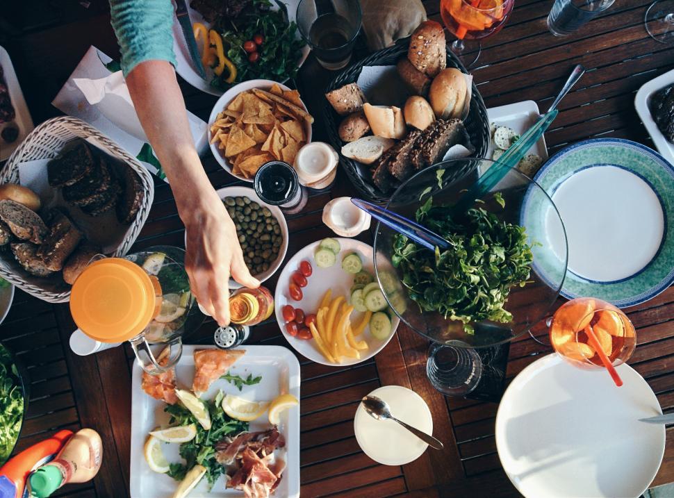 A woman enjoying food at a dining table, full of Peurto Rico's cuisines.