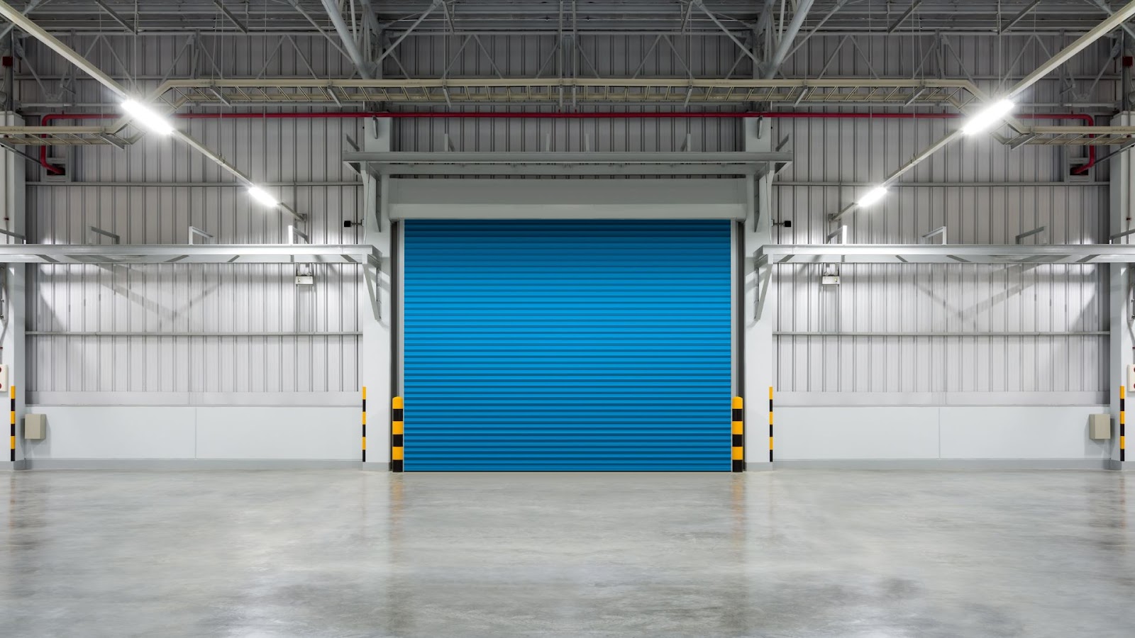 A blue high-performance garage door installed in a warehouse