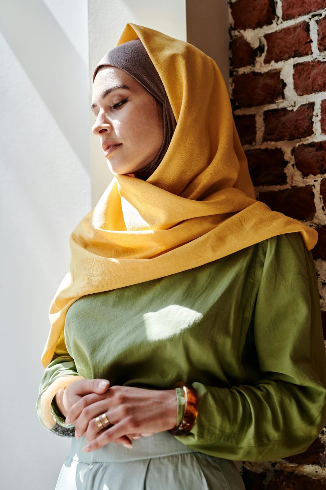 Alone, Sad Hijab Woman standing against the wall
