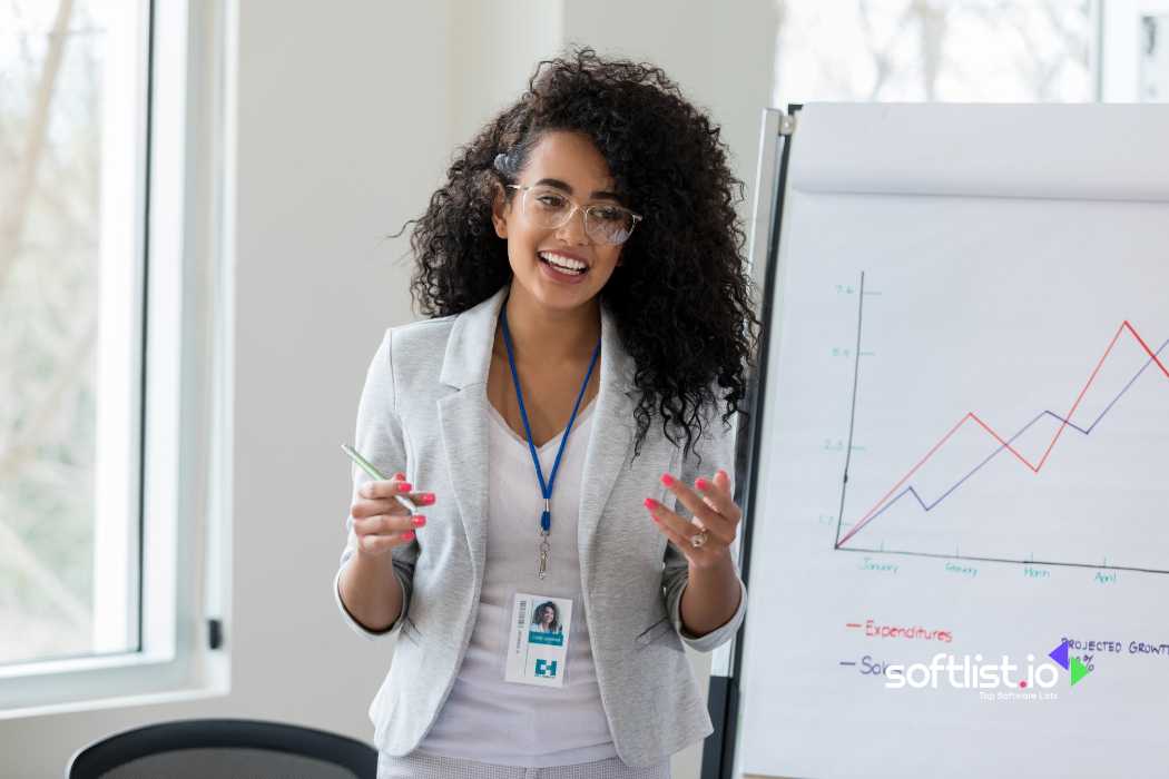 Woman presenting a graph on a flip chart, smiling