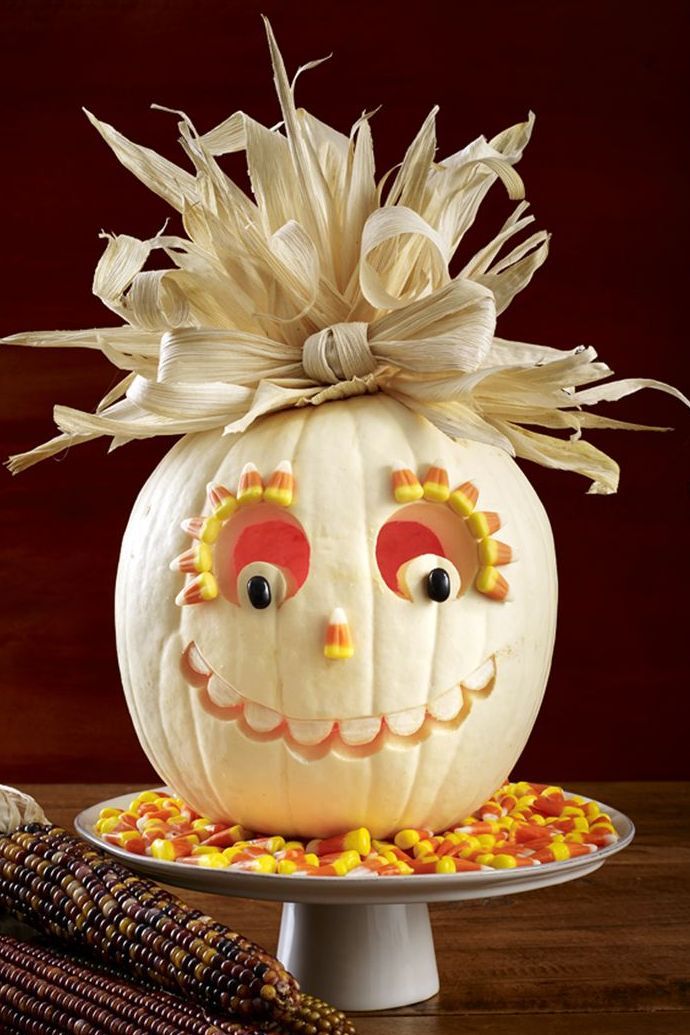 pumpkin carving ideas, white pumpkin with carved out eyes and candy corn