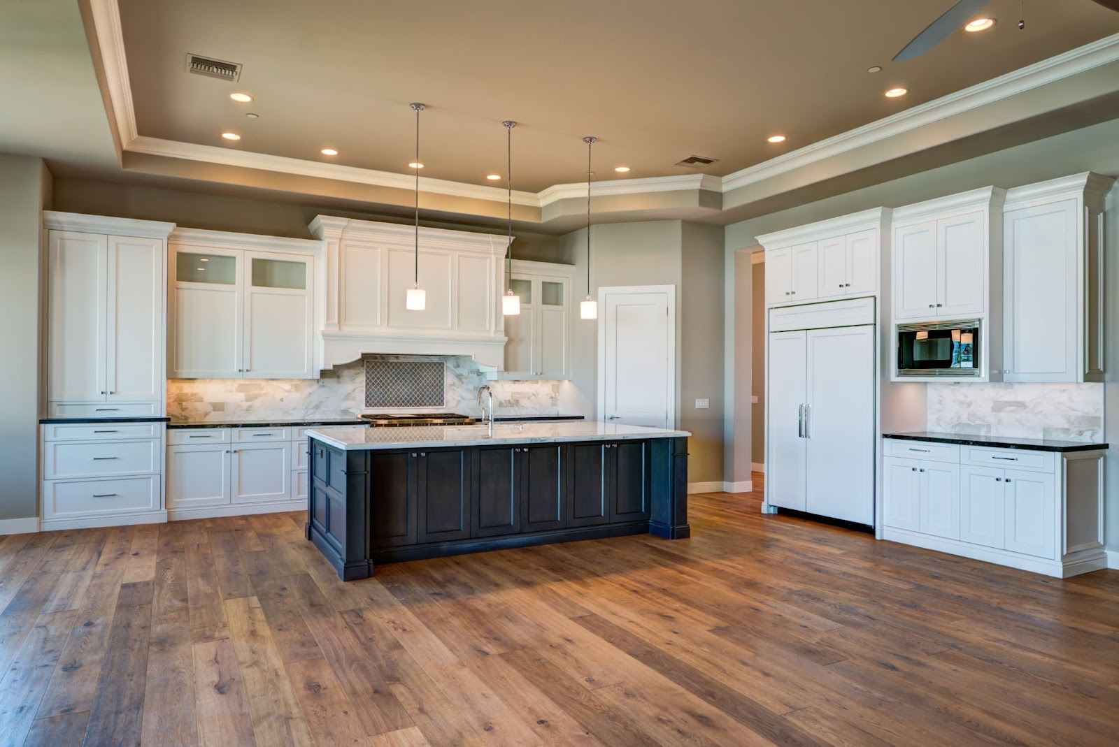 Beautiful kitchen remodeling featuring a large center island by Unique Stairways