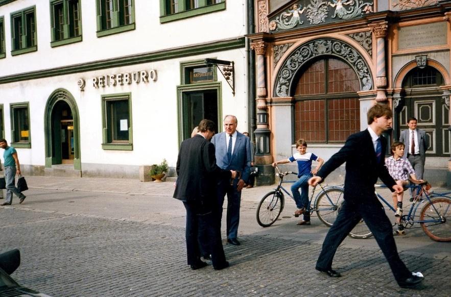 A group of men walking in the street

Description automatically generated