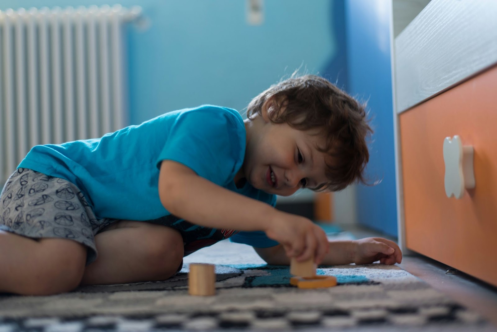 A young boy playing blocks on the floor