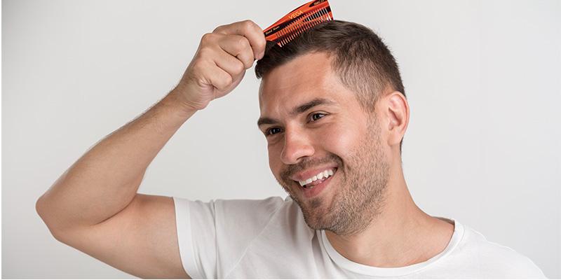 A person with a comb on his head

Description automatically generated