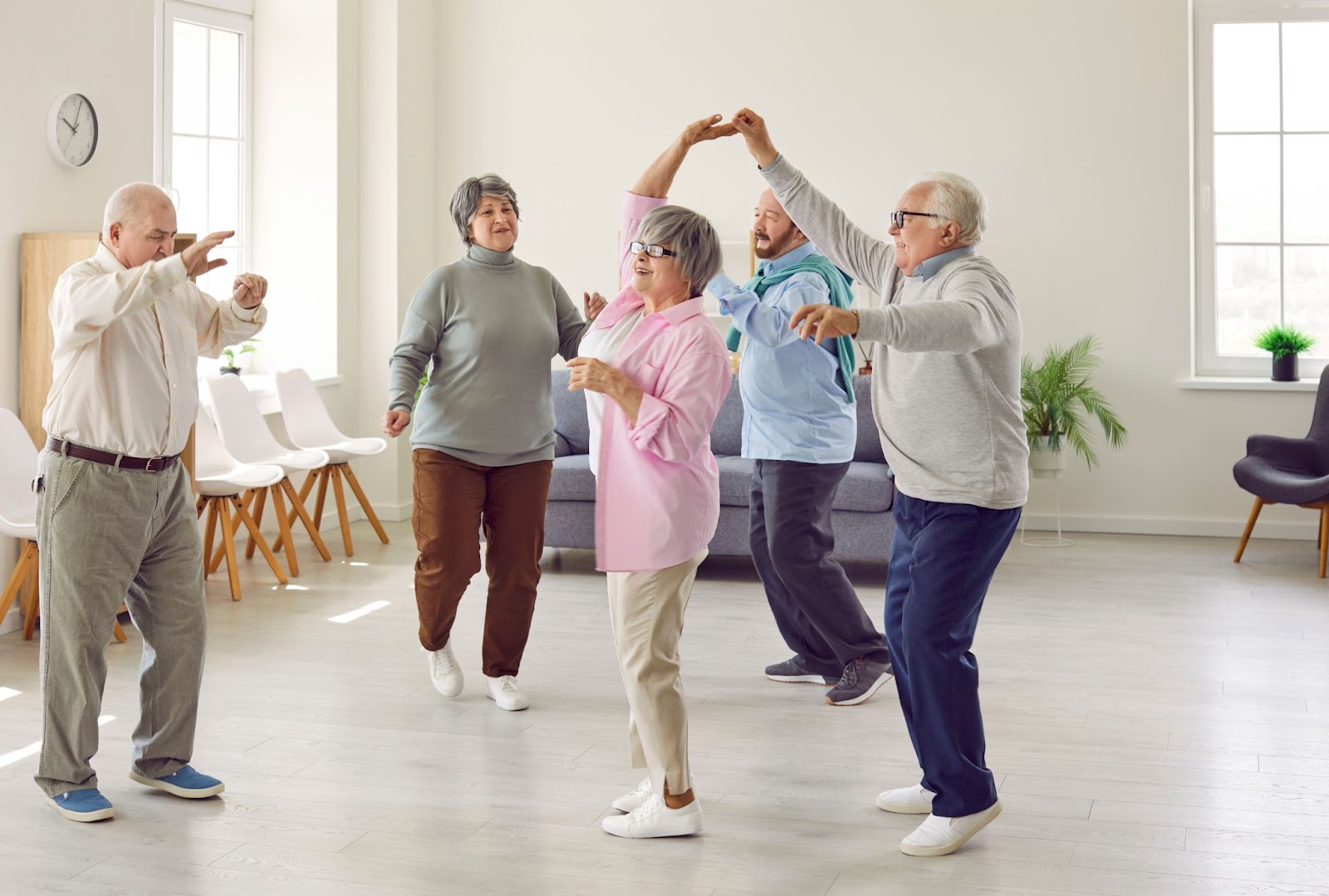 A group of older adults dancing in a senior community.