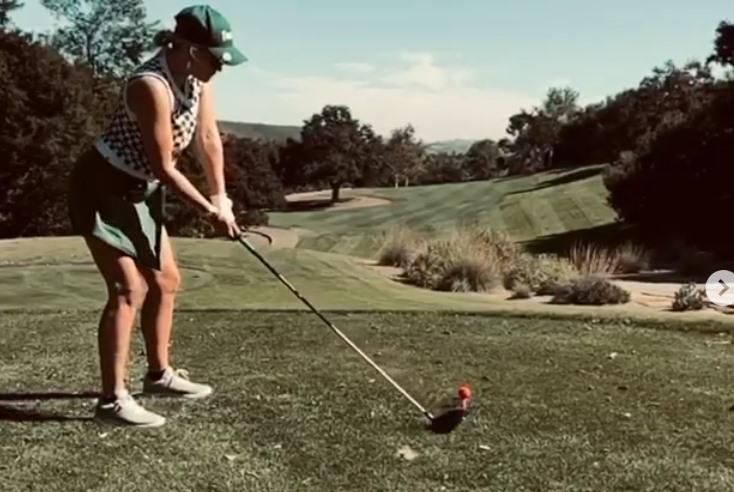 Emily Osment playing golf