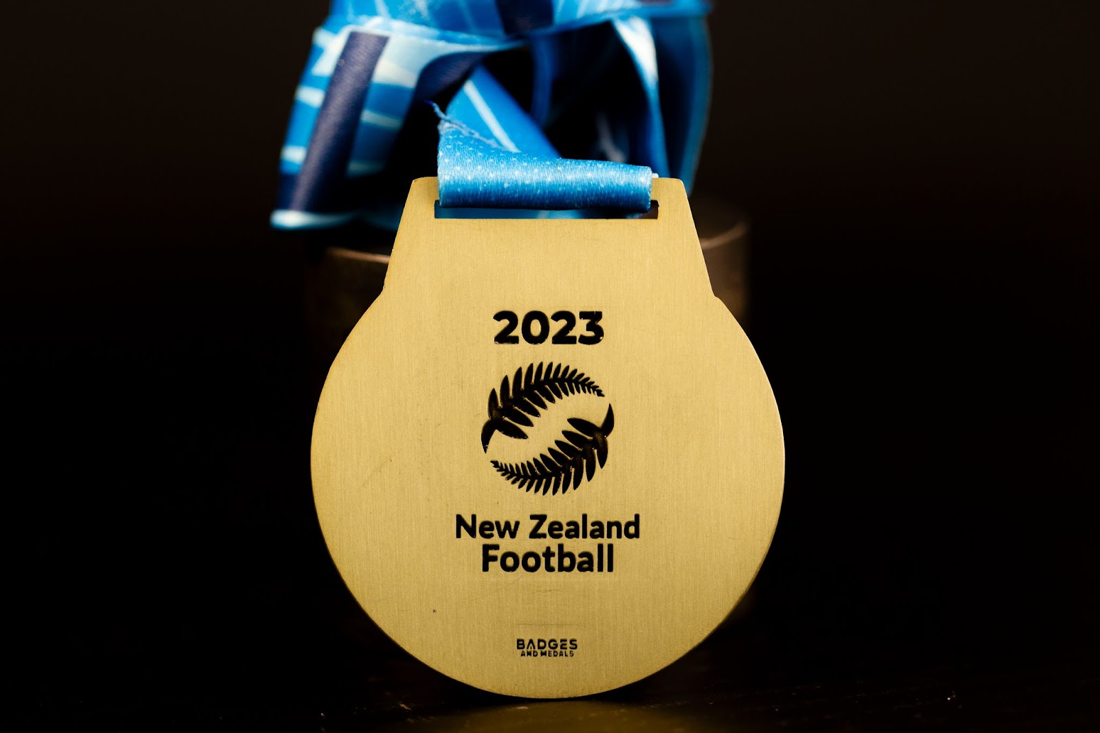 Custom New Zealand Football medal with engraving on the reverse.