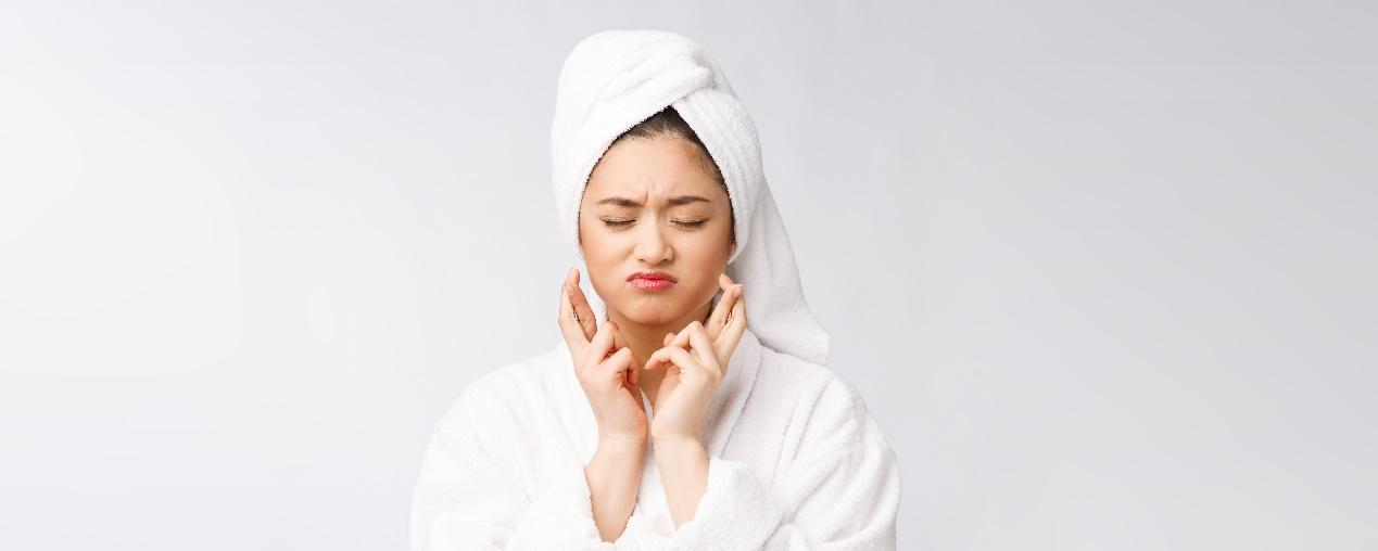 A person in a white robe with a towel on her head

Description automatically generated