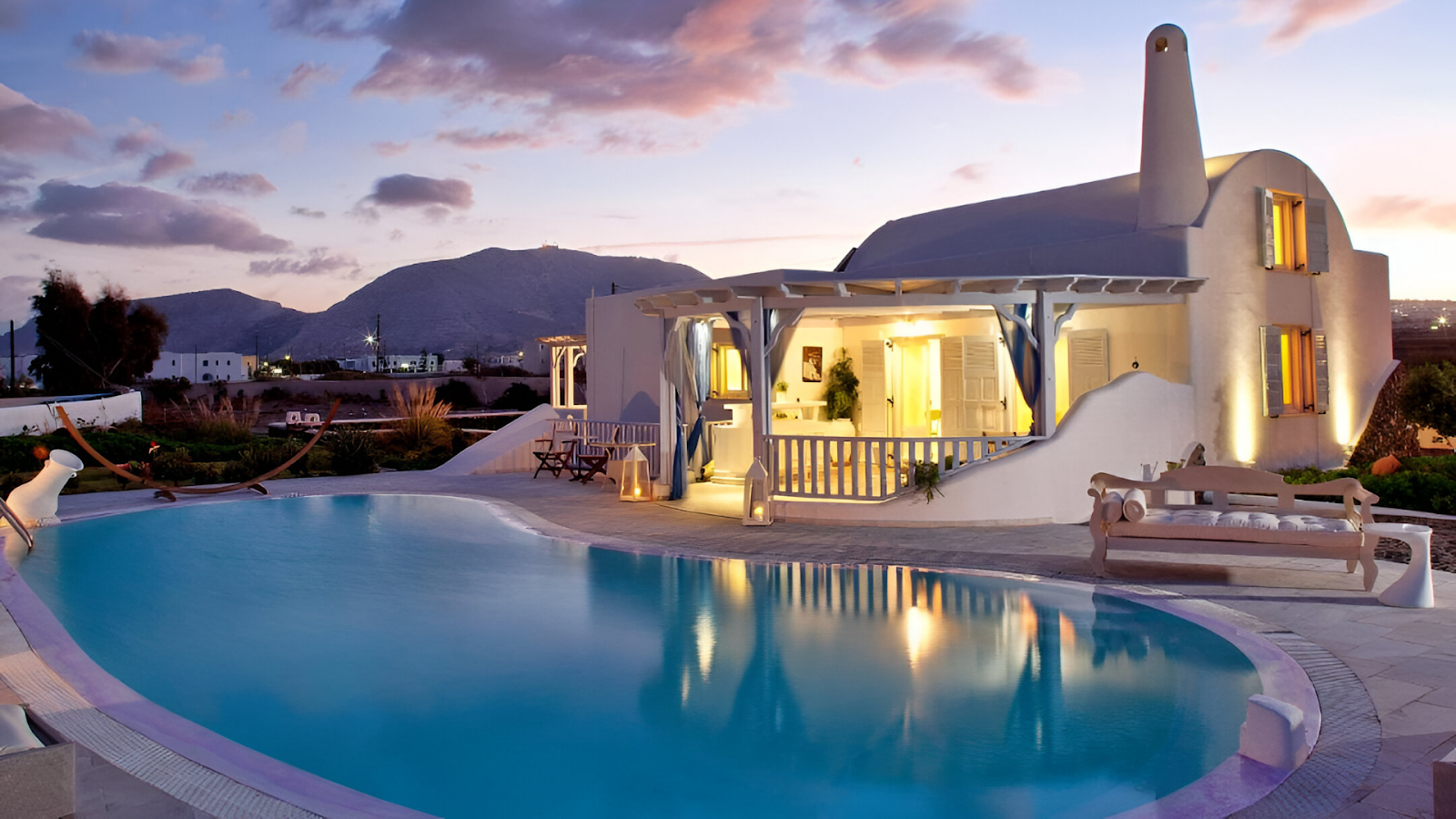 A pool of a vacation rental in Santorini with mountain views. 