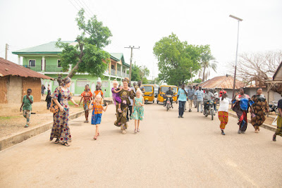 Picture: Left to right: Emily Gaddis, Lydia, Acacia, Christy and Mariama join the Bwatiye parade. Photo credit: Shadrach Yusuf