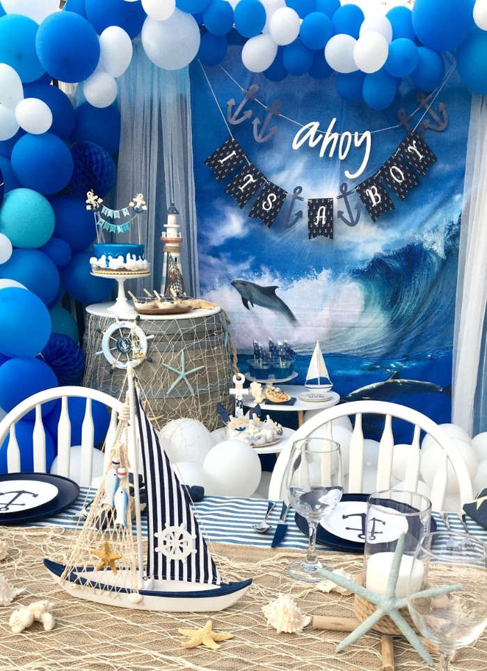 ahoy it's a boy sign hanging over nautical themed table