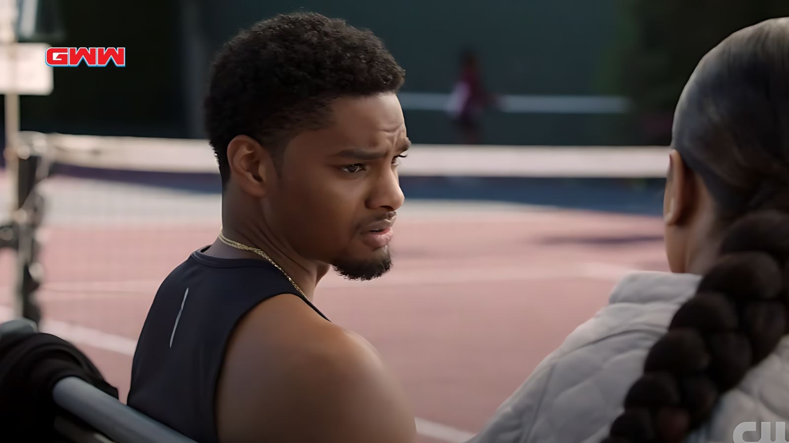 JR talking with Keisha on a tennis court.