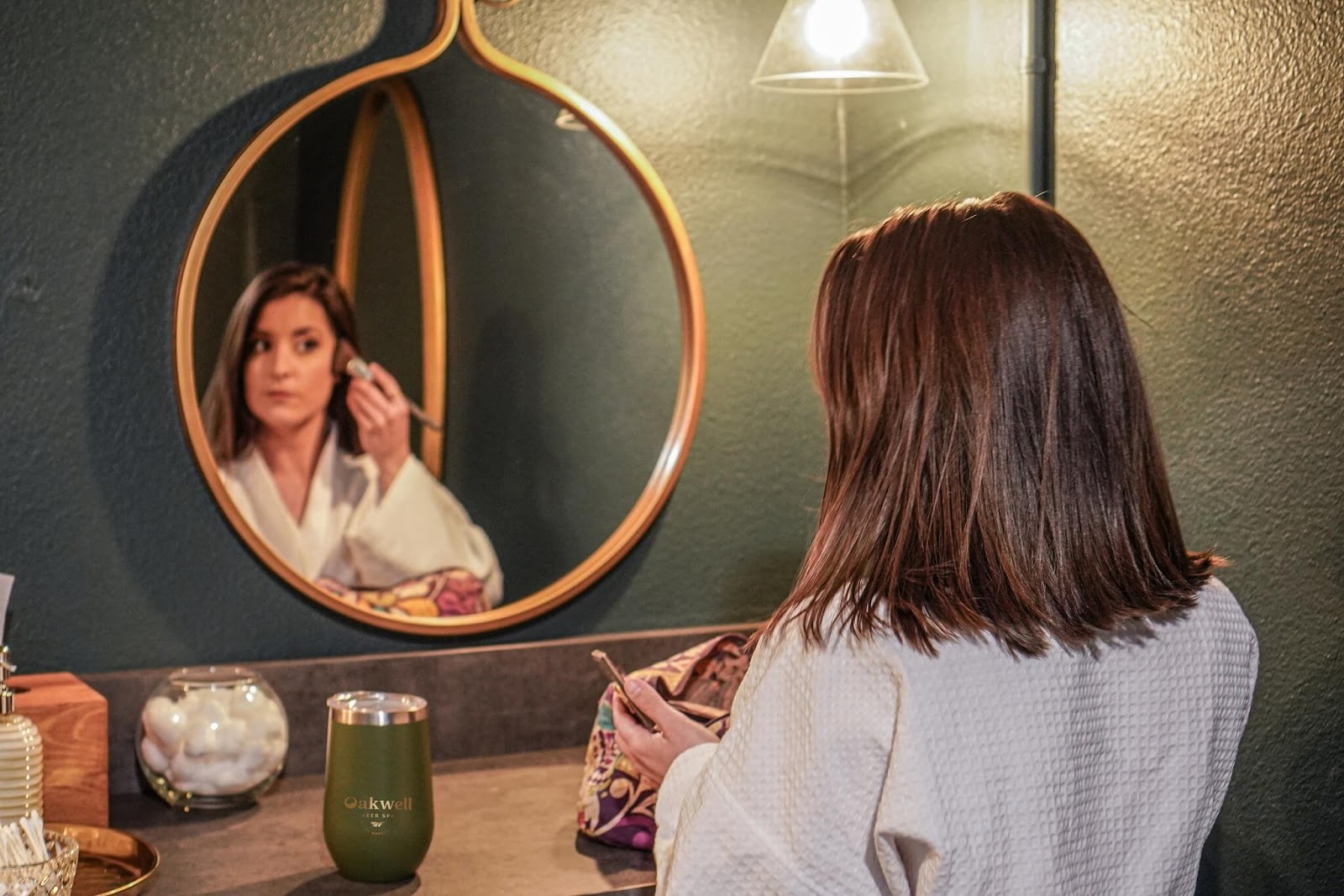 Woman putting on makeup in the Vanity Room at Oakwell Beer Spa