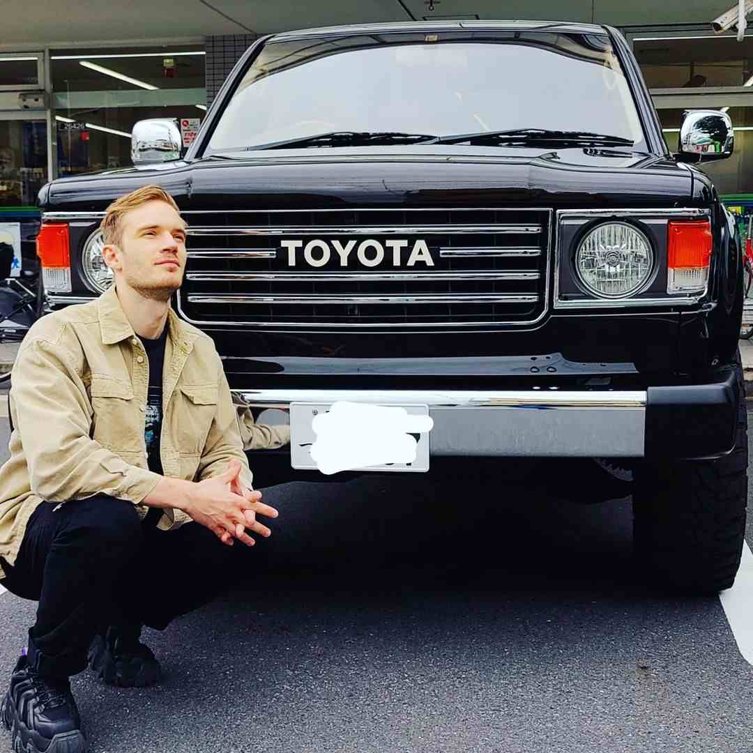 PewDiePie posing with his car