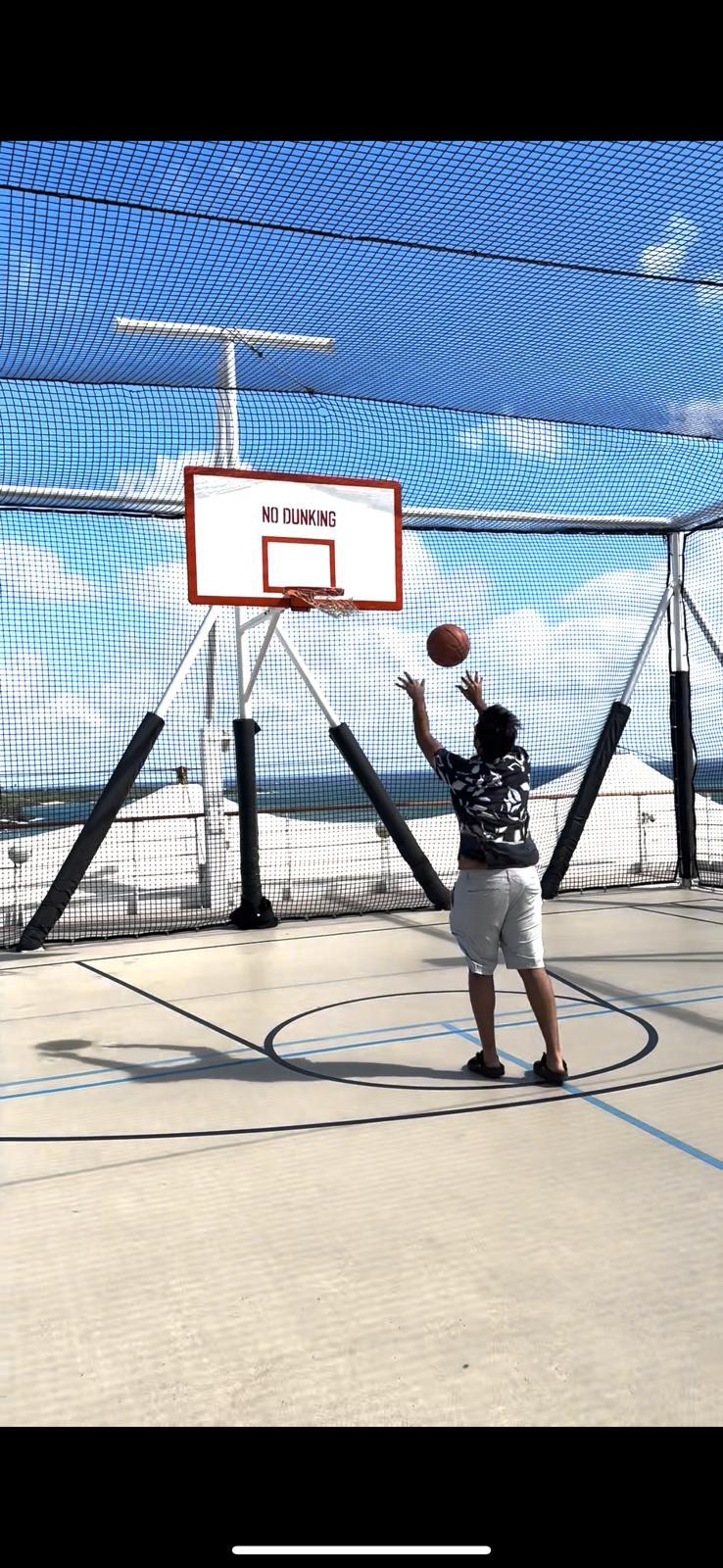 A person playing basketball on a court

Description automatically generated