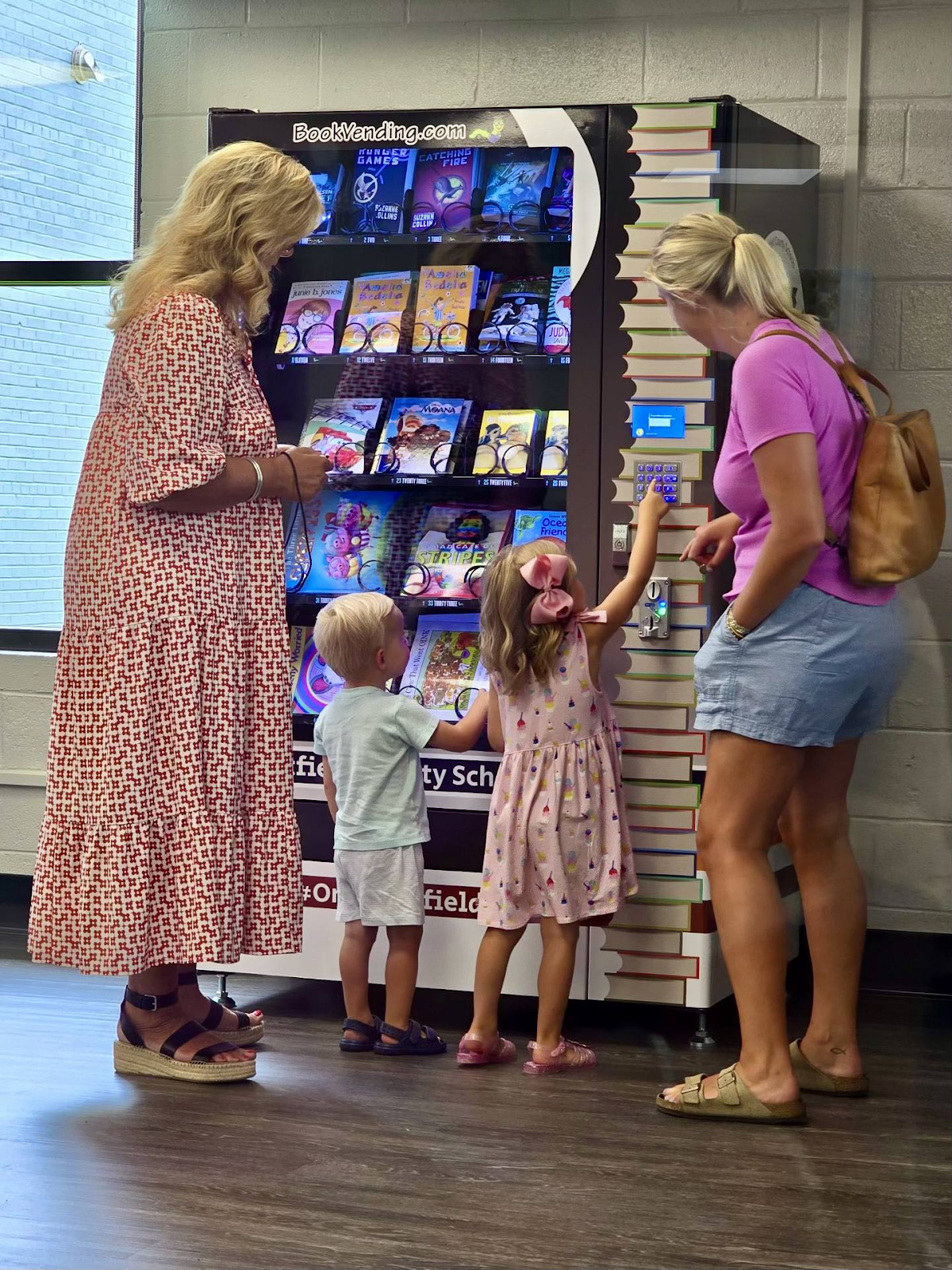 Parents and Students using Whitfield's Bookworm Vending machine