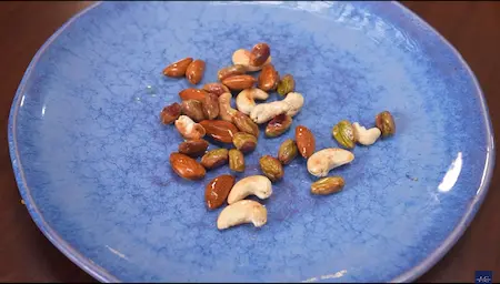 Pistachios, almonds, and cashews frying in ghee.