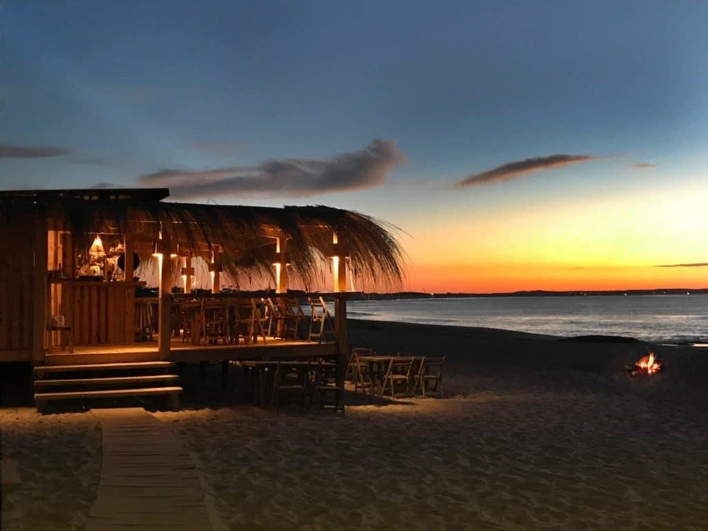 A beach bar with a sunset

Description automatically generated with medium confidence