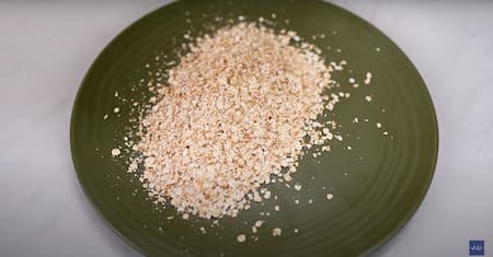 Roasting oats in a pan, creating a fragrant aroma.
