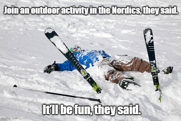 man lying in snow after ski fall